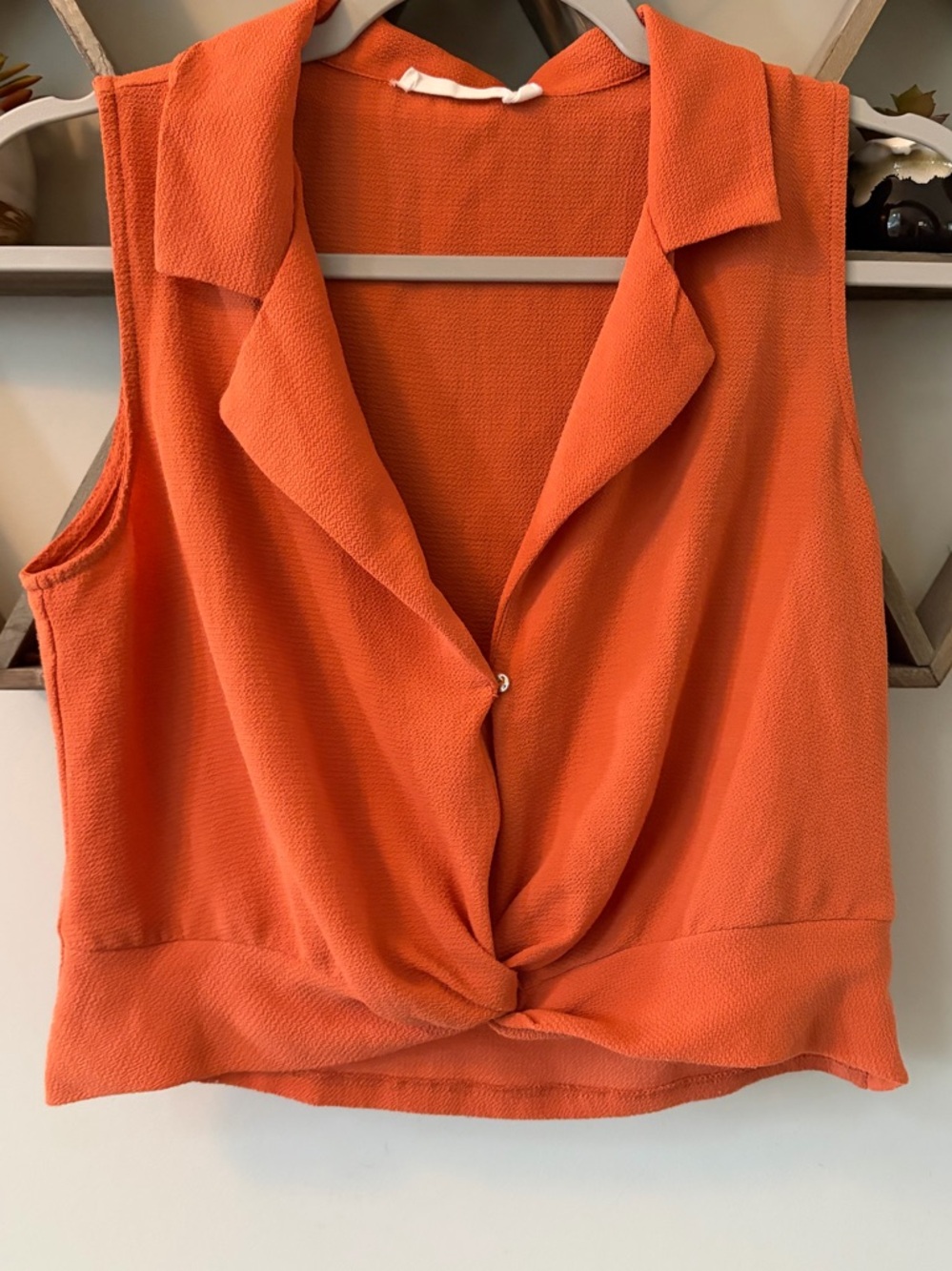 Lush sleeveless cropped twist front blouse in orange. Size small.